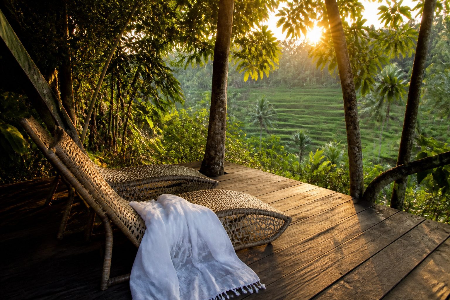 A couple watching a sunset from a beach in Bali.