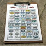 License plate bingo sheet on a clipboard with several plates crossed out.